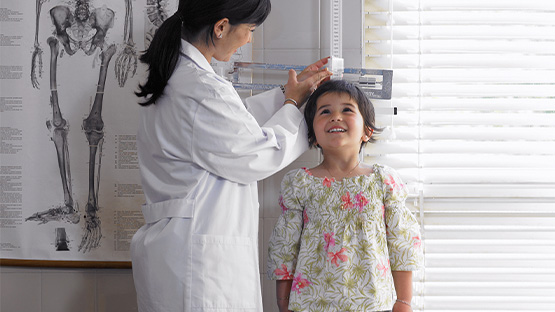 Doctor checking child's height