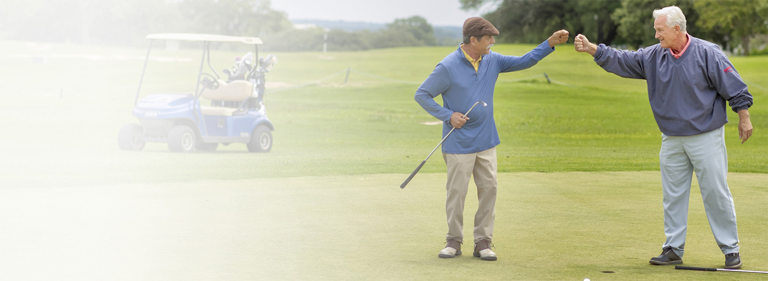 Two men playing golf