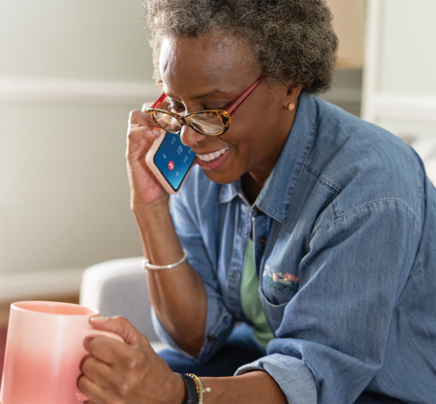 Lady on a phone call holding a mug