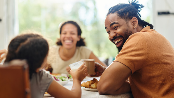 a family at the dinner table enjoying thier meal and interacting