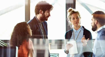 A diverse group of employees talking about business