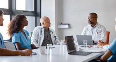 group of health professionals having a meeting around a table