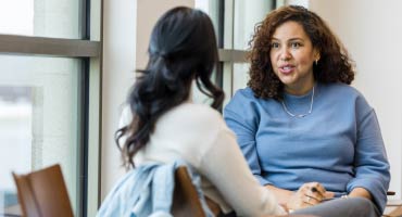 two females talking about social determinants of health