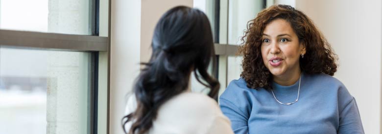 two females talking about social determinants of health