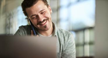 young man on the telephone looking at his spending accounts benefits 