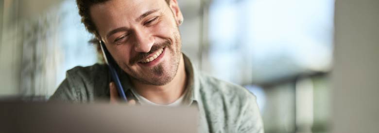 young man on the telephone looking at his spending accounts benefits 