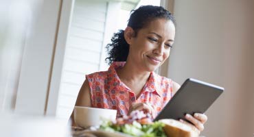 a women on a mobile tablet devise looking at her digital health experience