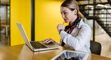 female working on a laptop computer working with a i  chatbots