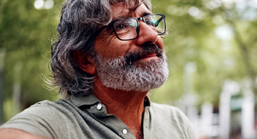 a middle age man in nature with a concerned look on his face