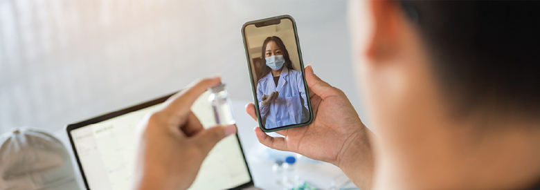 photo of a man using his mobile device to video chat with a medical professional