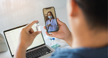 Man using his mobile device to video chat with a medical professional to illustrate Highmark innovations in health care. 
