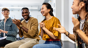 a group of young adults clapping