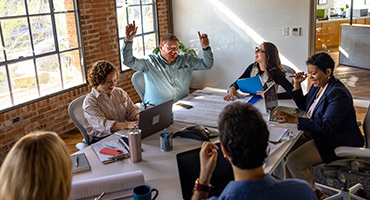 group of employees working together in a happy way