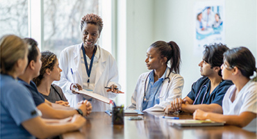 a group of doctors and nurses discussing a preventive care topic