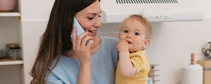 a mother on the phone holding her baby