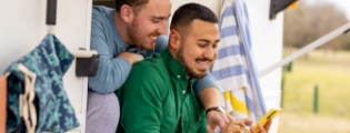 two men looking at a mobile phone calling customer service