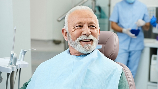 man sitting in dental chair waiting for his checkup