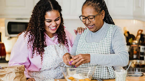 two women in a kitchen enjoying their time cooking