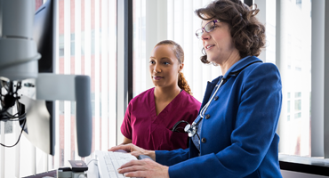 a doctor and a nurse working with test results