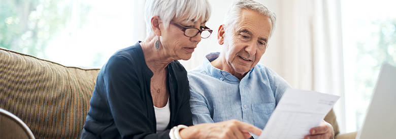 senior male and female looking at the difference between medicare ppo and hmo