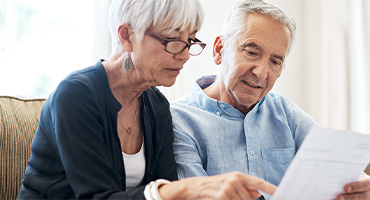 senior male and female looking at the difference between medicare ppo and hmo