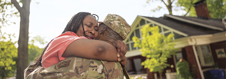 photo of a man in the military hugging a women