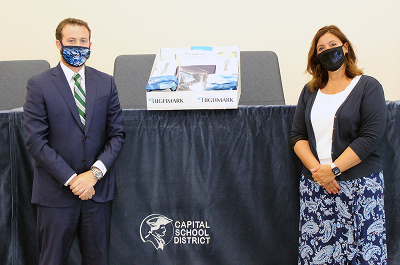 Adam Knox, Regional Vice President, Head of Commercial Business for Highmark Blue Cross Blue Shield Delaware (left) joins Dr. Sylvia Henderson, Superintendent of Capital School District, to present the Capital School District with a Highmark Back to Schoo