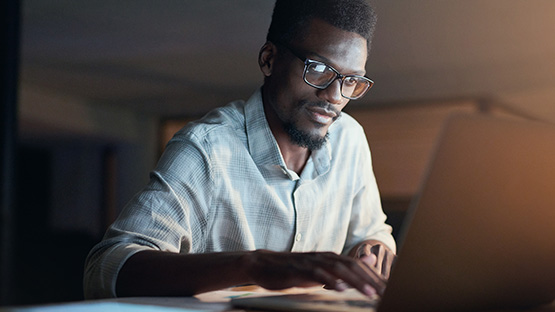 man searching for his health insurance id card find a doctor tool and deductible information on a computer