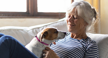 women on the couch with her dog