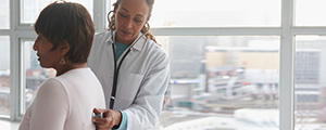 female doctor listening to a patients breathing