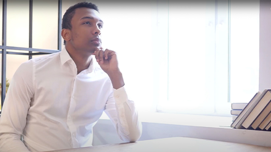 young man in thought at a table