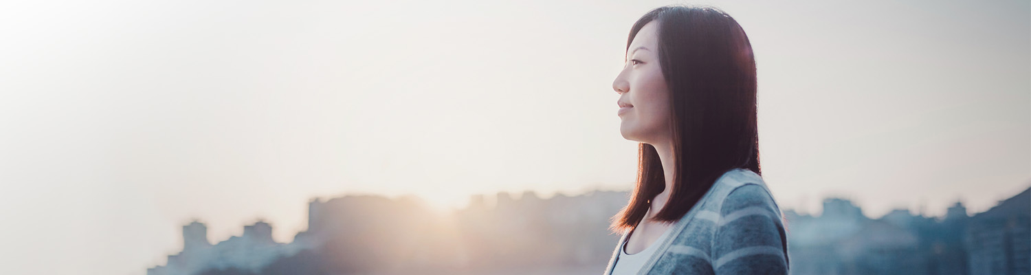 woman standing outside at sunrise