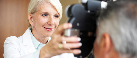 Female eye doctor with patient using a phoropter