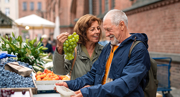 senior couple shopping at outdoor market