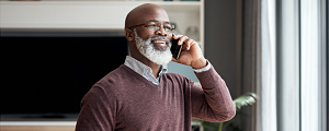 senior man smiling on cell phone