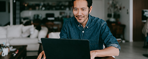 man smiling while on laptop