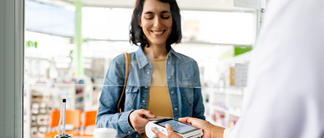 woman paying at pharmacy counter