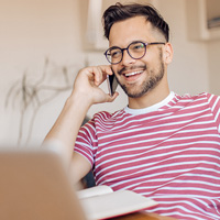 man at home using the phone and smiling