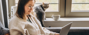 woman on laptop with her cat