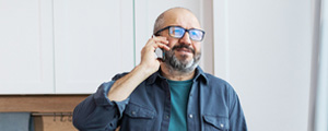 senior man smiling on cell phone