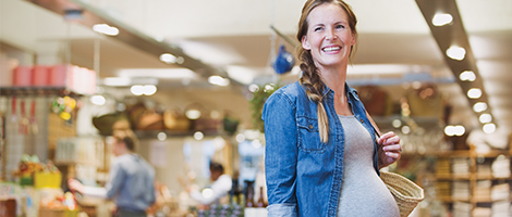 A pregnant woman is shopping at a local grocery store. 
