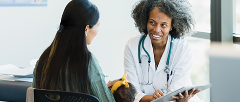 Woman and her baby are being consulted by a pediatrician. 