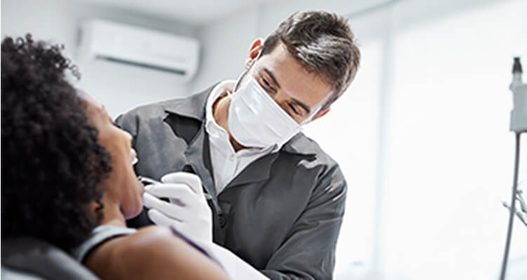 A dentist is working on a patient.