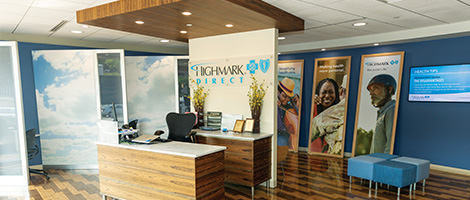Inside of a Highmark direct store- shows desk, chair and Highmark signs